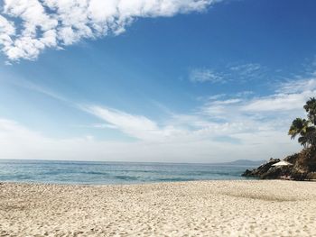 Scenic view of beach against blue sky