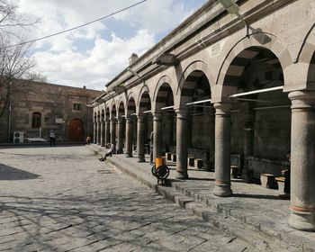 Street amidst buildings against sky in city