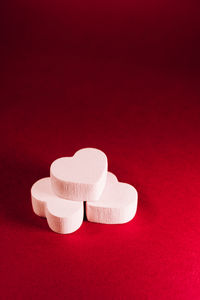 Close-up of heart shape on red table