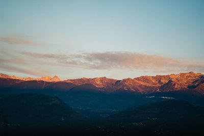 Scenic view of snowcapped mountains against sky during sunset