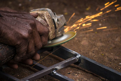 Close-up of worker cutting steel