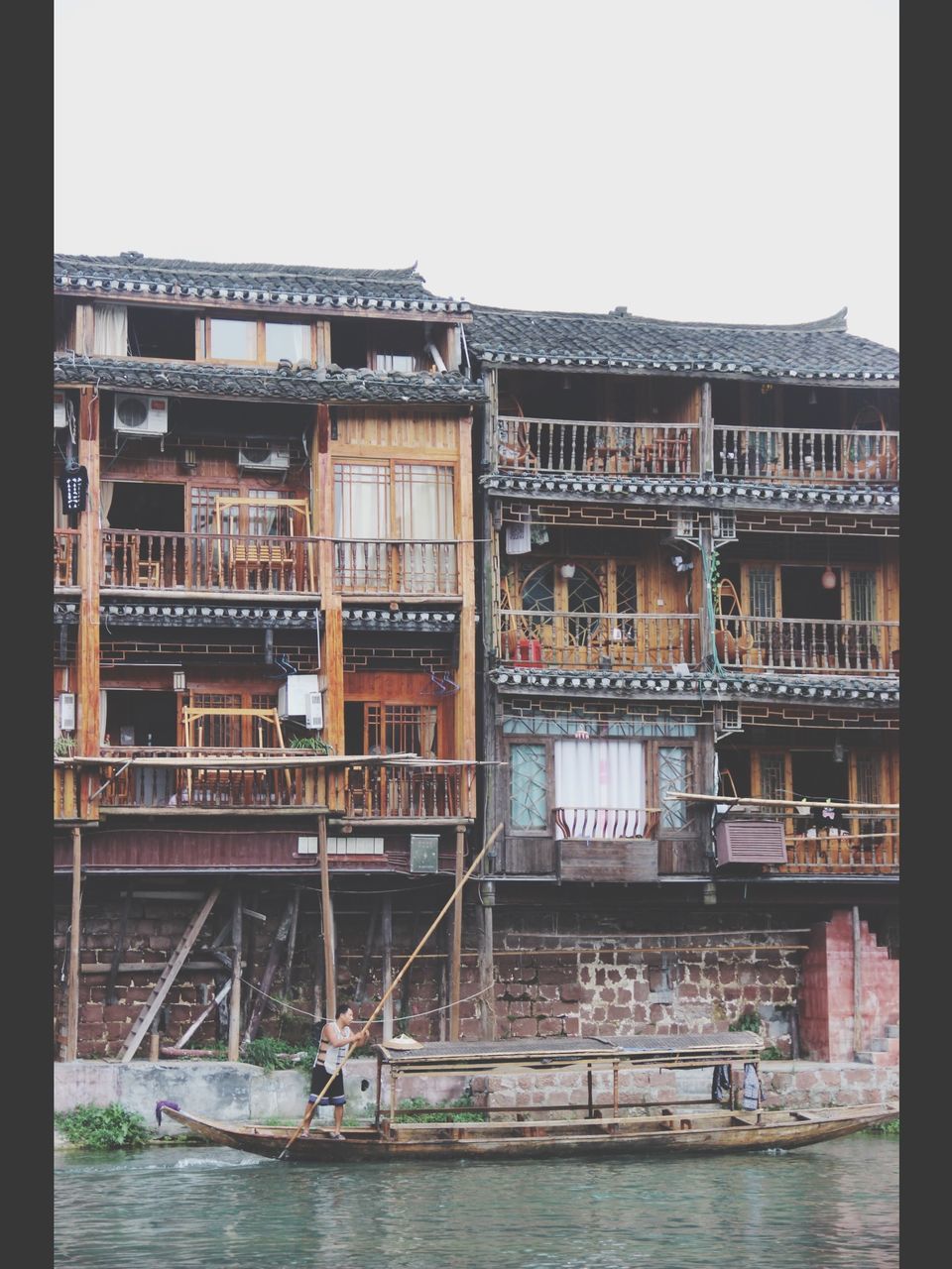 building exterior, architecture, built structure, transfer print, auto post production filter, city, residential structure, building, residential building, low angle view, outdoors, day, house, window, clear sky, no people, development, construction site, city life, balcony