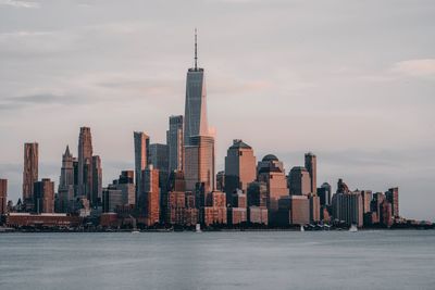 Modern buildings in new york manhattan against sky during sunset