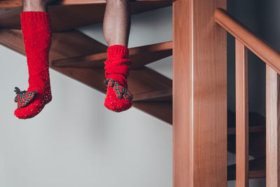 Low section of woman wearing red shoes