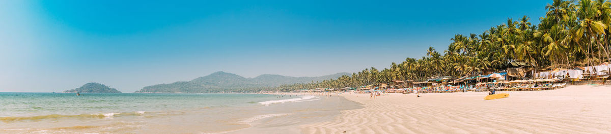 Scenic view of beach against clear blue sky