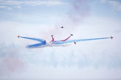 Low angle view of airplane flying against sky