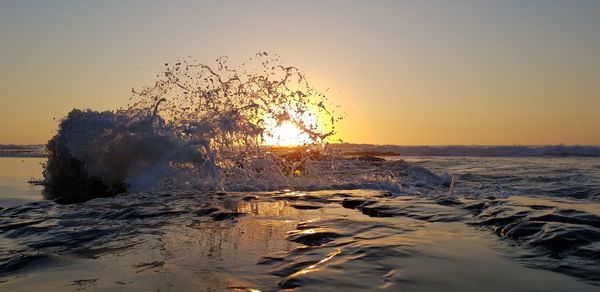 Scenic view of sea against clear sky during sunset