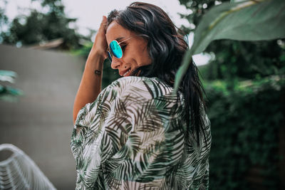 Side view of young woman standing outdoors