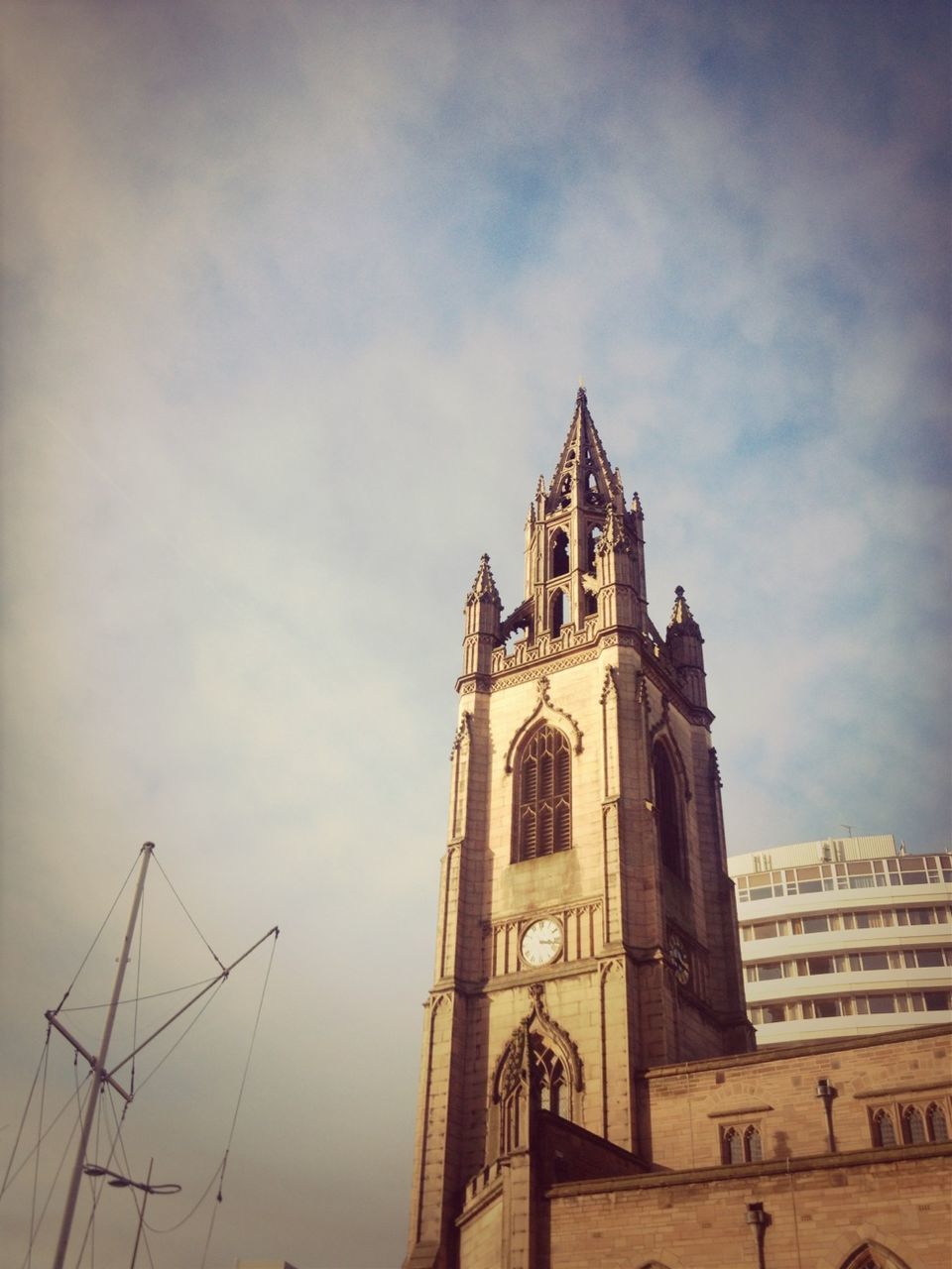 architecture, building exterior, built structure, church, religion, place of worship, sky, low angle view, spirituality, cloud - sky, clock tower, cathedral, tower, cross, cloud, outdoors, no people, cloudy