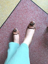 Low section of woman standing on floor