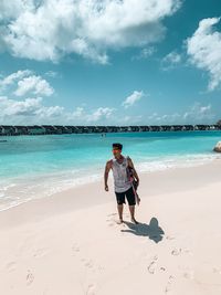 Full length of man on beach against sky