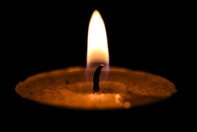 Soft candle light over black blurred background, inspirational peace mood