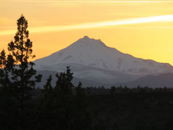 Scenic view of snowcapped mountains against sky during sunset