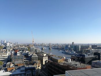 High angle view of city buildings against clear sky