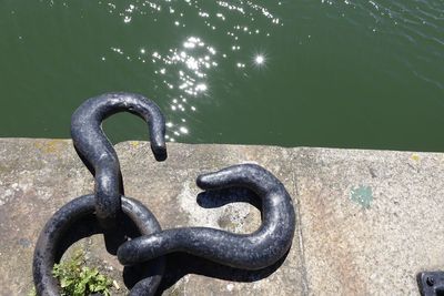 High angle view of chain on pier at lake