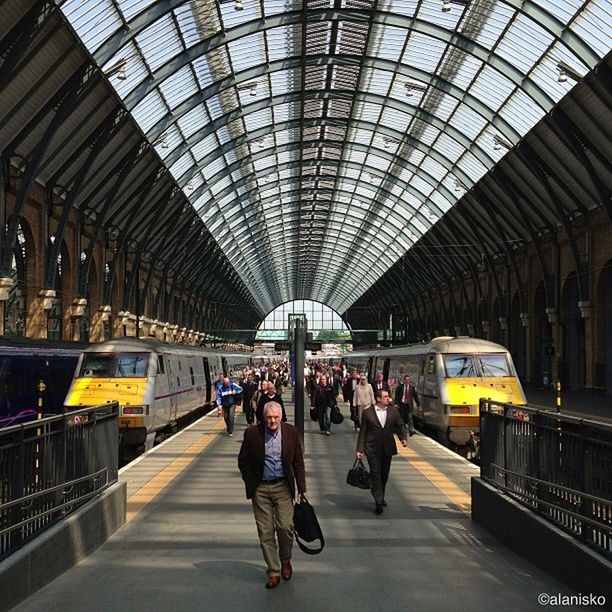 transportation, indoors, railroad station, public transportation, railroad station platform, men, rail transportation, subway station, person, architecture, large group of people, ceiling, travel, built structure, passenger, railroad track, walking, lifestyles, mode of transport