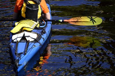 Reflection of man on boat in lake