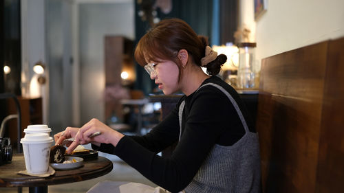 Side view of woman drinking glass