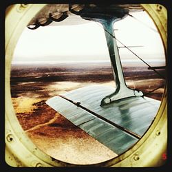 Cropped image of airplane on landscape