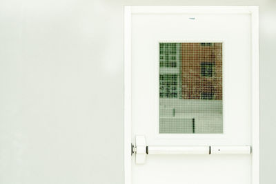 Close-up of window on white door