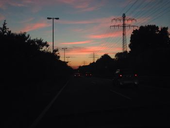 Cars on road at sunset