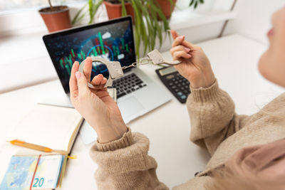 Midsection of woman using laptop on table