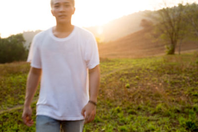 Man standing on field against sky