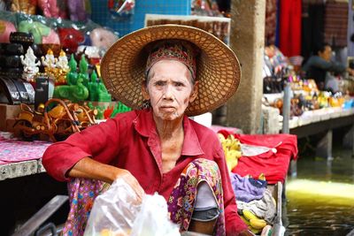 Portrait of senior vendor wearing conical hat