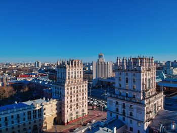 High angle view of buildings against blue sky