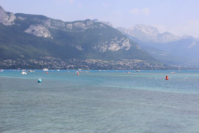 Scenic view of sea and mountains against sky