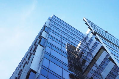 View of modern building against clear blue sky