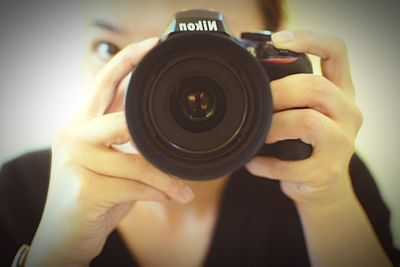 Cropped image of woman photographing through smart phone