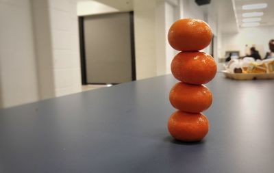 Close-up of stacked oranges on table