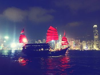 View of illuminated ship in river at night