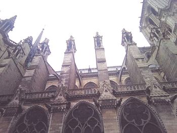 Low angle view of birds against clear sky