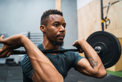 Full length of man exercising in gym