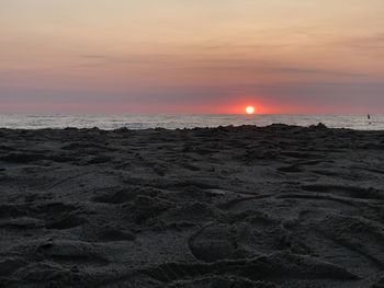Scenic view of beach against sky during sunset