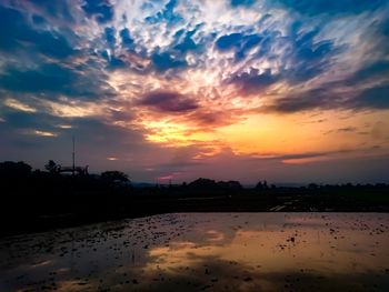 Scenic view of lake against sky during sunset