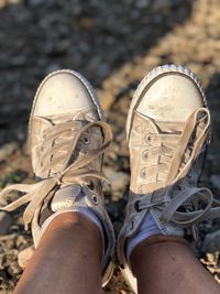 Low section of person wearing canvas shoes