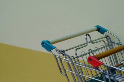 Close-up of bicycle wheel against yellow wall