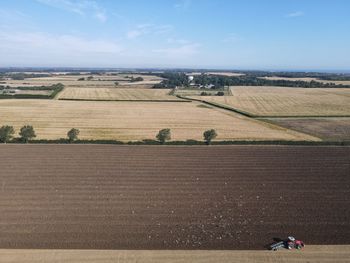 Drone shots of a farmer ploughing his late summer field