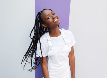 Young woman standing against white background