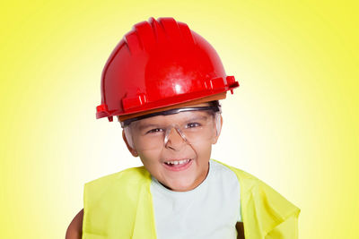 Portrait of boy against red background