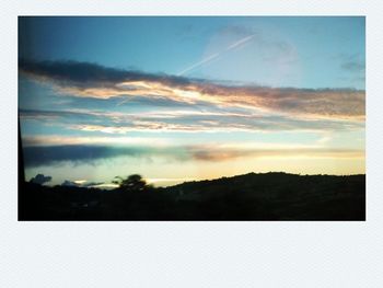 Scenic view of landscape against cloudy sky