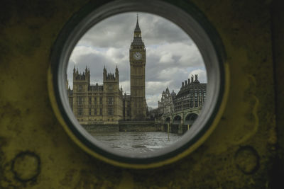 View of clock tower seen through round window