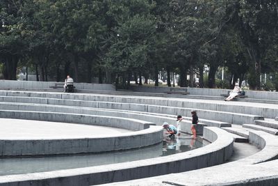 People on staircase in city