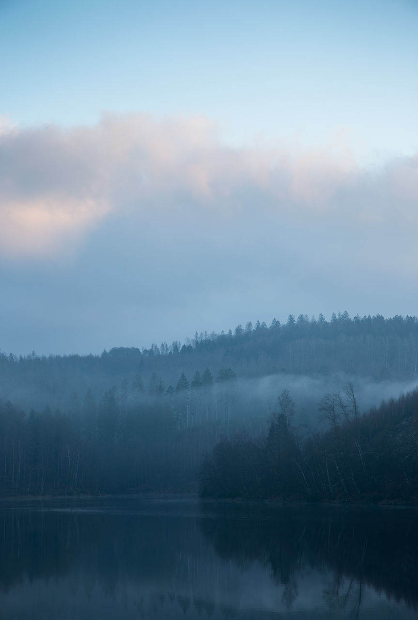 reflection, mist, tranquility, fog, scenics - nature, beauty in nature, tranquil scene, tree, sky, water, morning, lake, dawn, cloud, nature, environment, plant, no people, forest, landscape, idyllic, non-urban scene, mountain, sunrise, land, horizon, outdoors, twilight, woodland, day, remote, copy space, blue