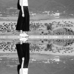 Reflection of woman standing on shore