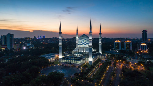 High angle view of illuminated buildings against sky during sunset