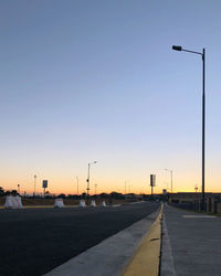 Street against clear sky at sunset